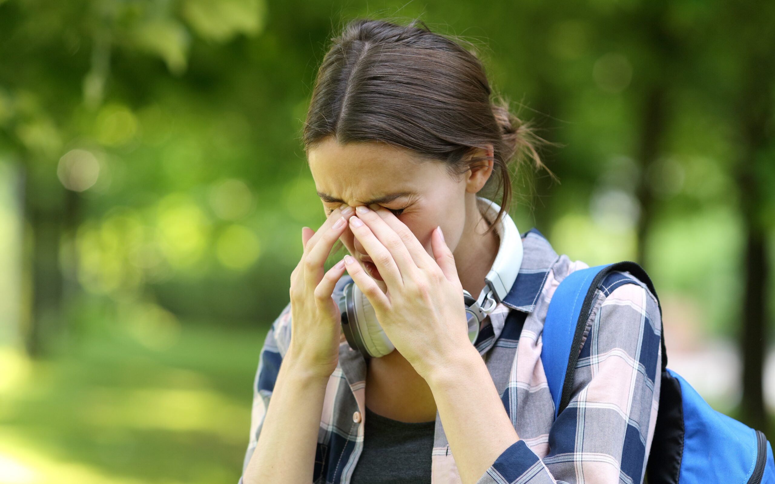 A young female college student struggling with allergies